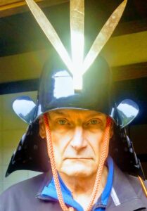 photo of George Sranko wearing a samurai helmet.